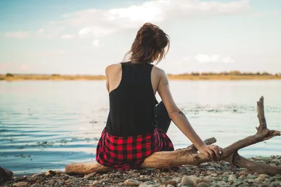 Woman Sitting on Driftwood by Calm Lake - free people & portraits wallpaper 2000×1333
