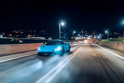 Blue Sports Car Speeding Across Illuminated Night Bridge - free cars & vehicles wallpaper 5910×3940