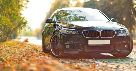 Black BMW Sedan Parked on Autumn Leaf-Covered Street - free cars & vehicles wallpaper 4096×2160