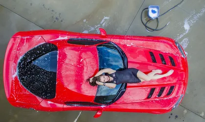 Woman Lying in Red Sports Car Top-Down View - free people & portraits wallpaper 2100×1254