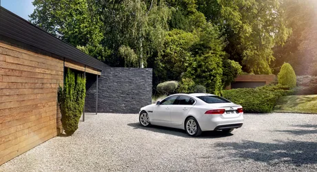 White Sedan Parked in Modern Luxury Driveway - free wallpaper 4096×2227