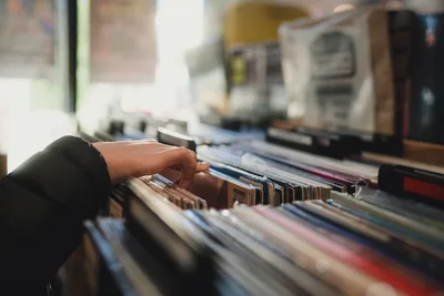 Hand Browsing Through Vinyl Records Collection - free wallpaper 6144×4096