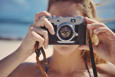 Woman Holding Vintage Camera at Beach - free wallpaper 2048×1367