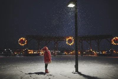 Child in Red Coat at Snowy Christmas Market at Night - free wallpaper 6016×4016