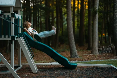 Child Playing on Blue Slide at Woodland Playground - free people & portraits wallpaper 6144×4096
