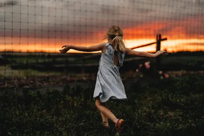 Girl With Arms Spread in Rural Sunset Field - free wallpaper 6144×4096