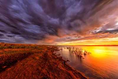 Dramatic Sunset Over Wetland with Stormy Sky - free wallpaper 8192×5464