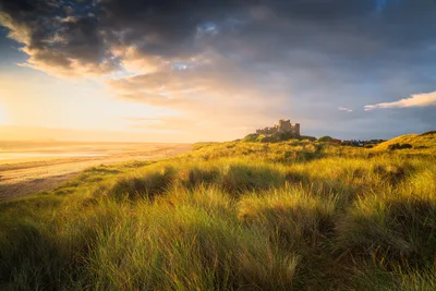 Castle on Coastal Hilltop at Golden Hour Sunset - free wallpaper 6144×4096