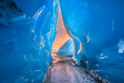 Ice Cave Tunnel Opening to Sunset Landscape - free wallpaper 6144×4096