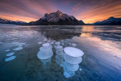 Frozen Lake with Methane Bubbles and Mountain Sunset - free wallpaper 6144×4100