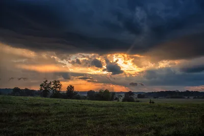 Dramatic Sunset Over Rural Farmland with Storm Clouds - free wallpaper 7360×4912