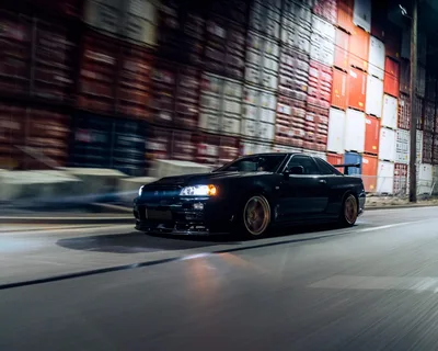 Black Sports Car Moving Through Industrial Port Area - free cars & vehicles wallpaper 4712×3770