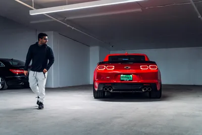 Man Jogging Past Red Chevrolet in Parking Garage - free cars & vehicles wallpaper 5945×3963