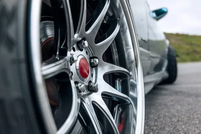Close-up of Silver Alloy Wheel with Red Center Cap - free cars & vehicles wallpaper 6720×4480