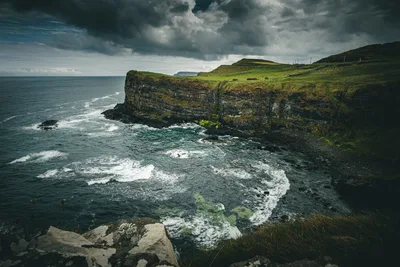 Dramatic Coastal Cliffs with Turbulent Sea and Green Hillside - free landscapes wallpaper 6000×4000