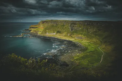 Dramatic Coastal Cliffs with Moss-Covered Terrain and Winding Path - free landscapes wallpaper 5911×3941