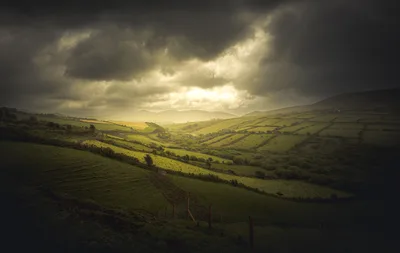 Rolling Green Valley Under Dramatic Storm Clouds - free landscapes wallpaper 6000×3795