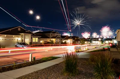 Suburban Street With Fireworks and Light Trails at Night - free photography wallpaper 4096×2706