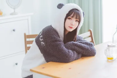Woman In Cozy Panda Onesie at Wooden Table - free wallpaper 2048×1367