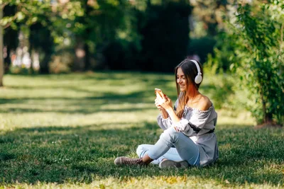 Woman With Headphones Using Phone in Park - free wallpaper 2048×1365