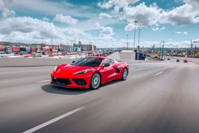Red Sports Car Driving Through Port Industrial Area - free wallpaper 6720×4480