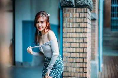 Woman Posing By Brick Wall in Urban Alley - free wallpaper 4000×2658