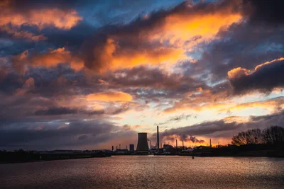 Industrial Cooling Tower at Sunset Over Water - free wallpaper 5967×3978