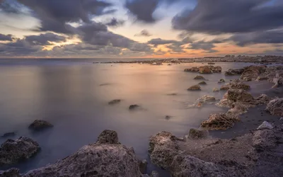 Rocky Coastal Sunset with Smooth Water and Clouds - free landscapes wallpaper 3277×2048