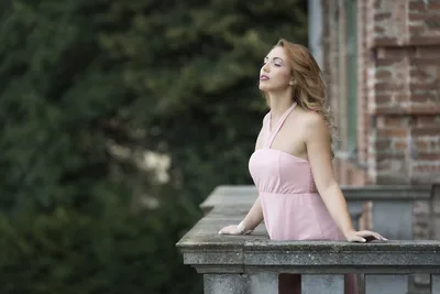 Woman in Pink Dress Sitting on Stone Ledge - free wallpaper 3000×2000