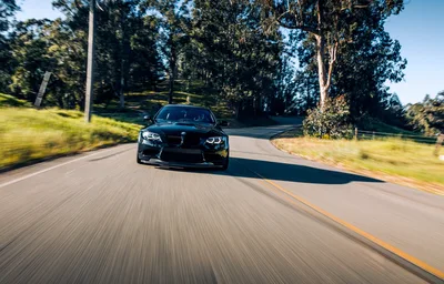 Black BMW Sports Car Driving on Tree-Lined Road - free cars & vehicles wallpaper 5809×3722