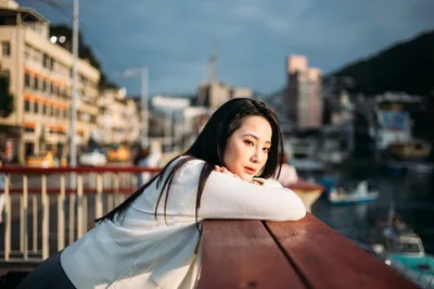 Woman Leaning on Railing Overlooking Urban Harbor - free people & portraits wallpaper 4000×2657