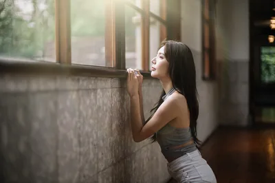 Woman Gazing Through Window in Sunlit Corridor - free people & portraits wallpaper 4000×2657