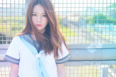 School Girl in Sailor Uniform by Chain-Link Fence - free wallpaper 2048×1365