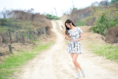 Young Woman on Rural Dirt Road in Floral Dress - free wallpaper 2048×1367
