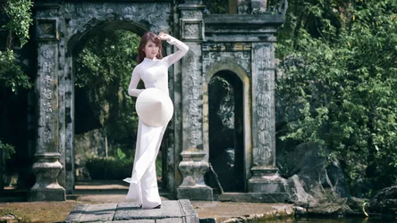Woman in White Áo Dài by Ancient Stone Gateway - free wallpaper 7217×4060