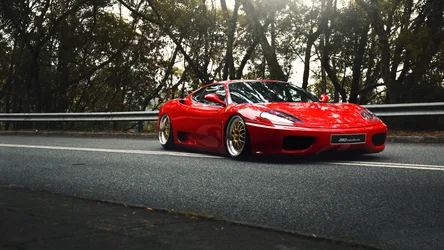 Red Ferrari Sports Car on Tree-Lined Highway - free cars & vehicles wallpaper 1920×1080