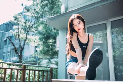 Woman Stretching on Modern Balcony with Green Plants - free people & portraits wallpaper 4000×2667