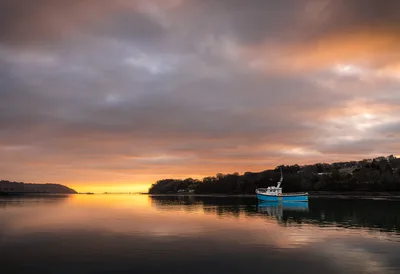 Blue Fishing Boat at Sunrise Over Calm Waters - free landscapes wallpaper 5646×3862