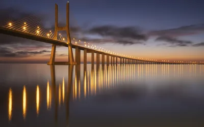 Illuminated Cable-Stayed Bridge at Twilight Over Calm Water - free wallpaper 4800×3000