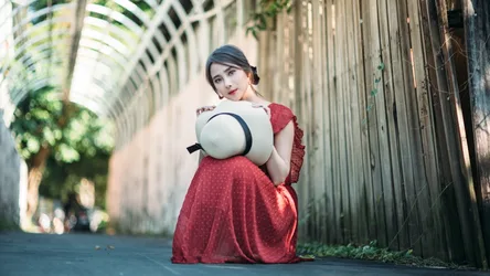 Woman in Red Dress Holding White Hat in Alley - free people & portraits wallpaper 4000×2249