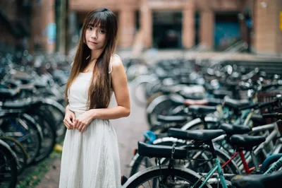 Young Woman in White Dress Among Parked Bicycles - free people & portraits wallpaper 4000×2658