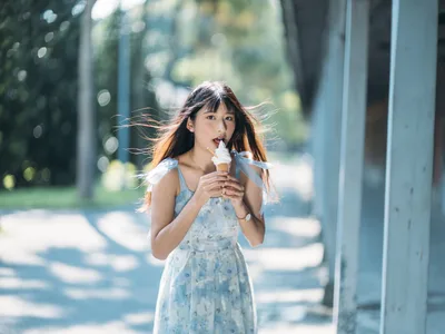Young Woman Eating Ice Cream in Sunlit Corridor - free people & portraits wallpaper 4000×3000