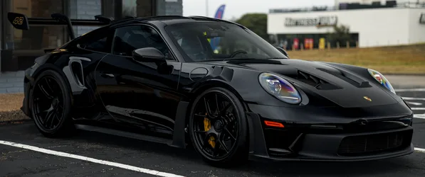 Black Porsche GT3 RS in Motion - free wallpaper 3440×1440