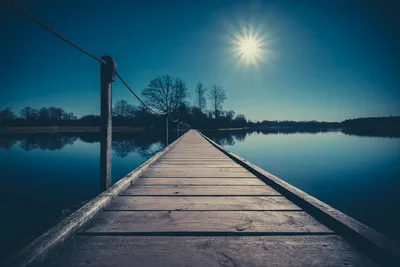 Wooden Pier Extending Into Calm Blue Lake at Sunrise - free photography wallpaper 2048×1365