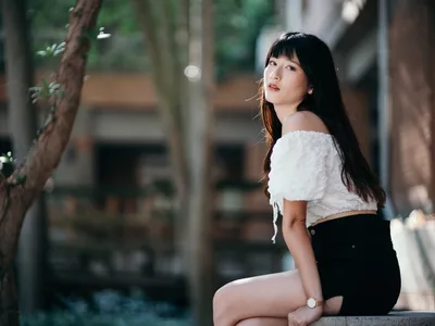 Young Woman in White Crop Top Seated Outdoors - free wallpaper 4000×3000