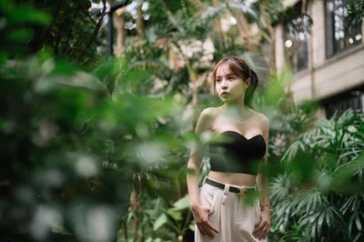 Woman in Black Crop Top Among Lush Green Plants - free wallpaper 4000×2658