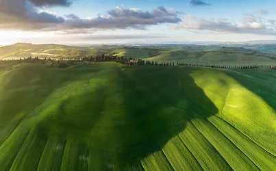 Rolling Green Hills with Tuscan Villa and Cypress Trees - free wallpaper 2047×1270