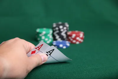 Poker Hand With Aces and Chips on Green Table - free photography wallpaper 5616×3744