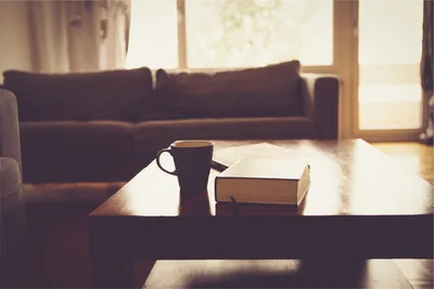 Cozy Living Room with Coffee and Book by Sunlit Window - free photography wallpaper 2509×1673