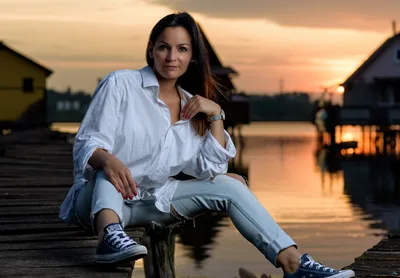 Woman Posing on Dock at Sunset Over Water - free wallpaper 7680×5325